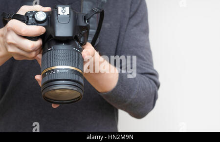 photographer hands holding camera Stock Photo