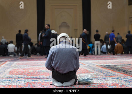 Old man praying in a mosque, Shiraz, Iran Stock Photo