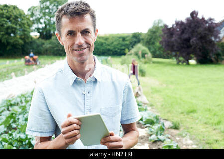Male Agricultural Worker Using Digital Tablet In Field Stock Photo