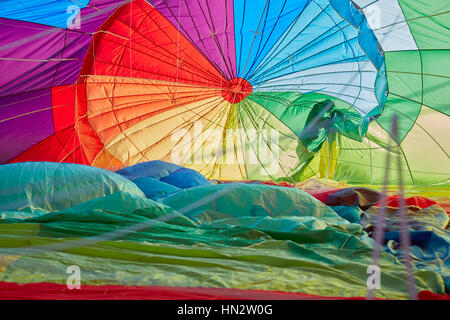 Hot air balloon inflating inside view, man shadow in backlight Stock Photo