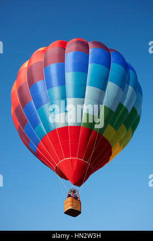 Hot air balloon, colorful aerostat on blue sky Stock Photo