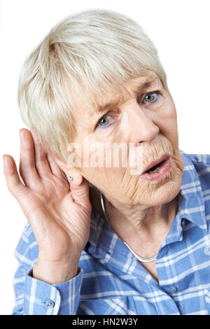 Studio Shot Of  Senior Woman Suffering From Deafness Stock Photo
