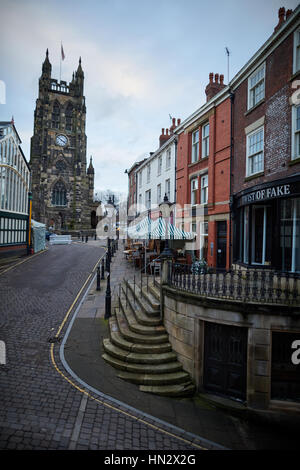 Landmark St Mary's Church on Stockport Market on a dull winter day showing the exterior of the Indoor Market Hall and independent shops in historic bu Stock Photo