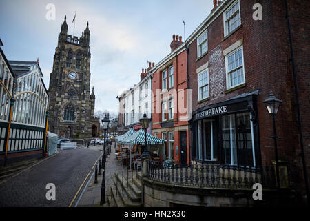 Landmark St Mary's Church on Stockport Market on a dull winter day showing the exterior of the Indoor Market Hall and independent shops in historic bu Stock Photo