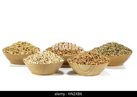 assortment of different cereals in wooden bowls isolated on white background Stock Photo