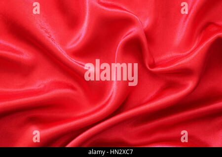 Red silk fabric draped in the form of heart for Valentine's day background Stock Photo