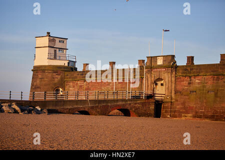 Liverpool bay Golden orange sunrise at New Brighton Fort Perch Rock and beach at  Marine Promenade in Wallasey, Merseyside, Wirral, England, UK. Stock Photo