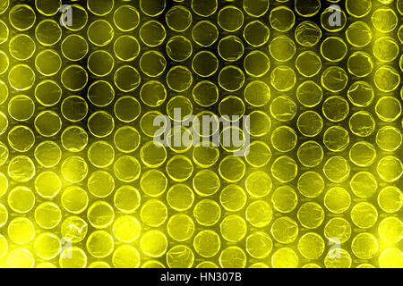 Plastic polymer bubble wrap in high contrast vivid yellow color Stock Photo