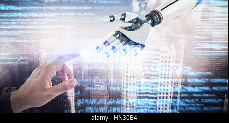 Businessman hand using digital screen against aerial view of a city on a cloudy day Stock Photo