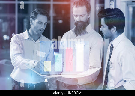Graph against businessmen discussing over blueprint Stock Photo