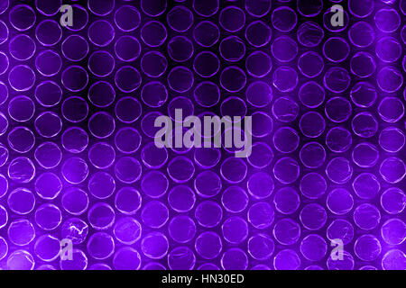 Plastic polymer bubble wrap in high contrast vivid purple color Stock Photo