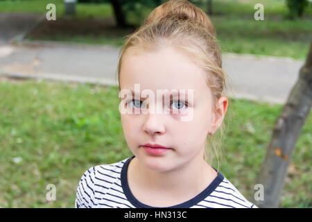 Cute girl with blond long hair and blue eyes Stock Photo