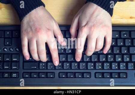 Close up of typing female hands on keyboard, top of view. Stock Photo