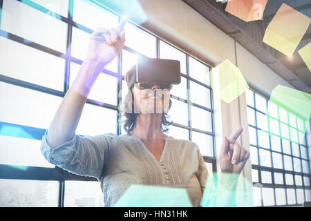 Digitally generated grey cubes floating  against business executive wearing virtual reality headset 3d Stock Photo