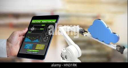 Man using tablet pc against workshop Stock Photo