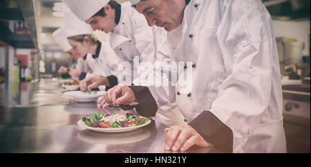 Chefs preparing their salads in the kitchen Stock Photo