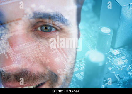 Man with green eyes against micro parts in mother board Stock Photo