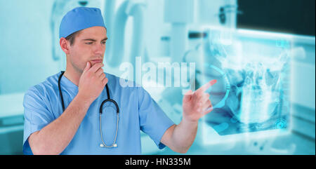 Surgeon pretending to be using futuristic digital screen against modern examing room Stock Photo