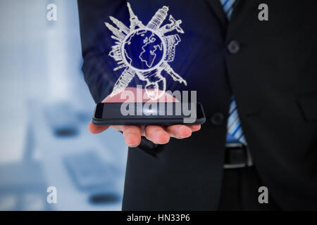 Midsection of businessman holding mobile phone against computers and headsets Stock Photo