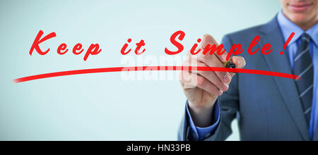 Midsection of well dressed businessman holding marker against vignette Stock Photo