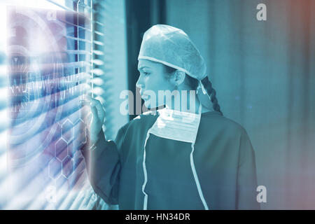 Medical interface on xray against female surgeon looking through window 3d Stock Photo