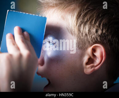 A boy using a Cardboard VR virtual reality headset Stock Photo