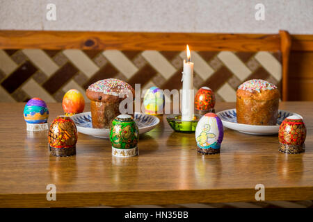 Easter Eggs, cakes and candle light on a table Stock Photo