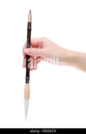 Hand holding traditional writing brush on white background Stock Photo