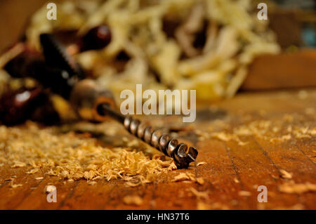 Close up of auger bit & hand powered drill in woodshop. Stock Photo