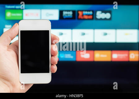 connection of phone and smart tv on blurred background Stock Photo