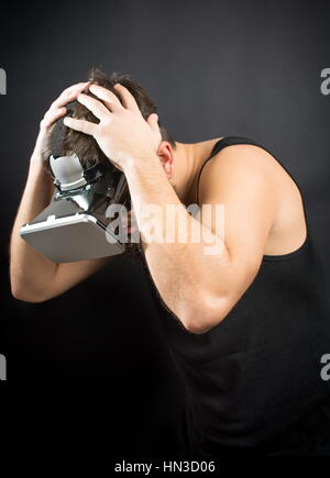 Scared bearded man wearing VR glasses Stock Photo