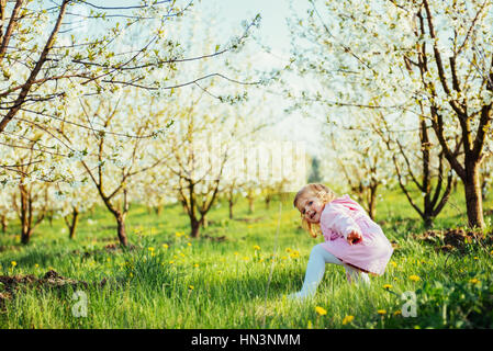 child running outdoors blossom trees. Art processing and retouch Stock Photo