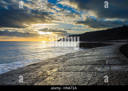Lyme Regis, Dorset, UK.  8th February 2017.  UK Weather.  A dramatic sunset viewed from The Cobb harbour wall at Lyme Regis in Dorset.  Picture Credit: Graham Hunt/Alamy Live News