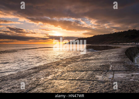 Lyme Regis, Dorset, UK.  8th February 2017.  UK Weather.  A dramatic sunset viewed from The Cobb harbour wall at Lyme Regis in Dorset.  Picture Credit: Graham Hunt/Alamy Live News Stock Photo