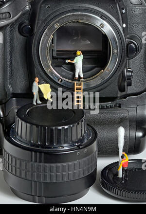 Camera sensor cleaning by figurines Stock Photo