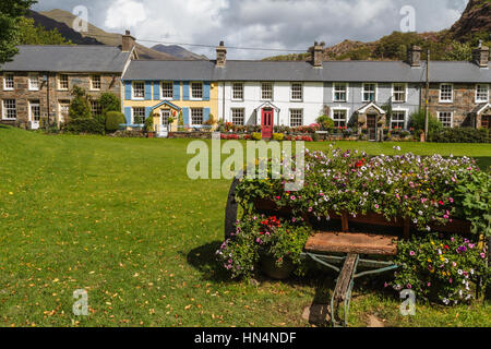 Row of traditional stone cottages adjacent to village green at Beddgelert, Wales Stock Photo