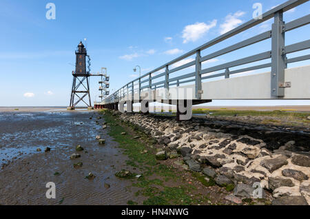 Dorum, Germany - August 9, 2015: Obereversand lighthouse at Dorum in the wadden sea. The lighthouse was erected 1887 in the Weser mound and moved to i Stock Photo