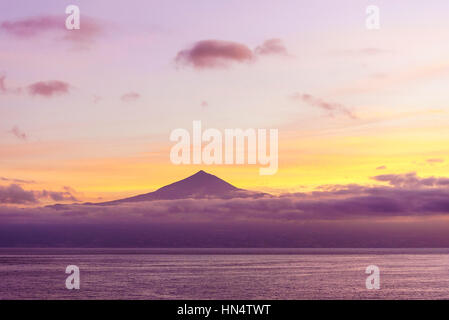 sunrise over mt teide, tenerife from the sea with low clouds Stock Photo