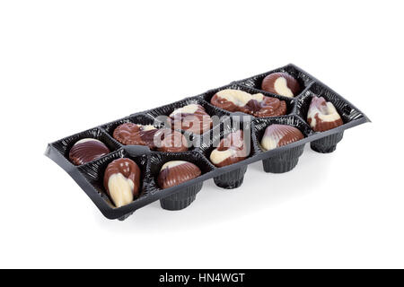 Tray of Belgian bonbons shaped as seashells isolated on white background Stock Photo