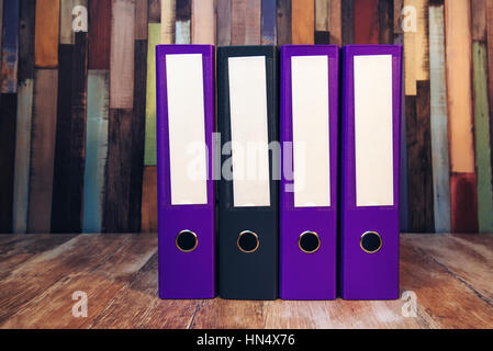 Four document ring binders with blank labels on accountant's office desk Stock Photo