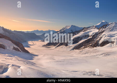 Sunrise over the Aletsch Glacier from Jungfraujoch in Switzerland on a clear morning. Stock Photo