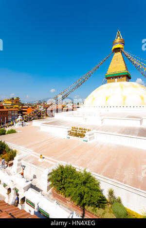 High angle view of Boudhanath Stupa and surrounding buildings on blue sky day in Kathmandu, Nepal Stock Photo