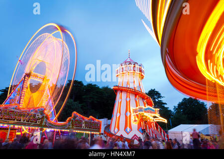 Bristol, United Kingdom - August 13, 2011: Evening Funfair rides within the grounds of Ashton Court during the Bristol Balloon Fiesta in 2011. The peo Stock Photo