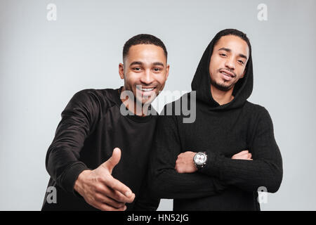 Two smiling african american young men standing and pointing on you Stock Photo