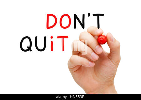 Hand writing Do Not Quit, Do It concept with marker on transparent glass board. Stock Photo