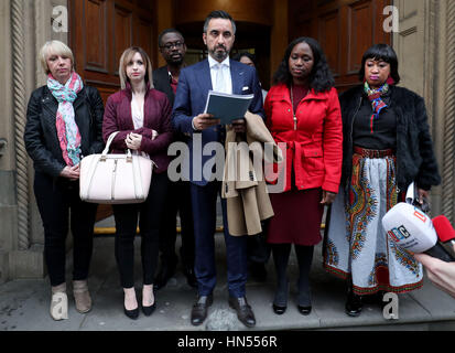 Solicitor Aamer Anwar reads a statement to the media outside the Crown Office in Edinburgh after family members of the late Sheku Bayoh, who died in police custody, met with the Lord Advocate. Left to right: Lorraine Bell (mother of Collette Bell), Collette Bell (partner of Mr Bayoh), Ade Johnson (brother-in-law of Mr Bayoh), Aamer Anwar, and Mr Bayoh's sisters Adama Jalloh (obscured), Kadi Johnson and Kosna Bayoh. Stock Photo