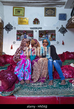 Harari sisters inside their traditional decorated house, Harari Region, Harar, Ethiopia Stock Photo