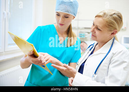 Female doctors discussing some medical records Stock Photo