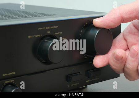 Hand adjusting hi.fi volume Stock Photo