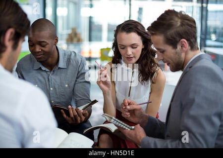 Business executives discussing during meeting in office Stock Photo